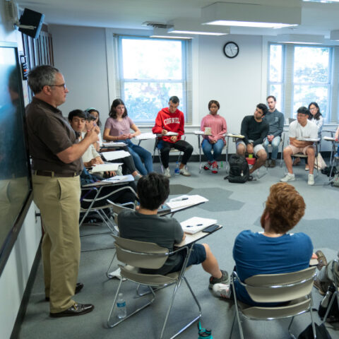 CIW students sitting in a circle in classroom