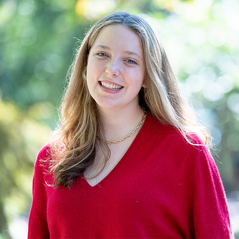 Student wearing red sweater outside