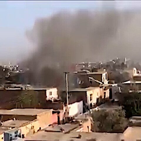 view of Kabul from above with smoke coming out of building