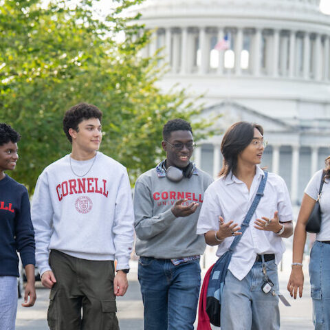 Five students walking in front of the Capitol Building in Washington D.C.