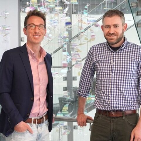 Brooks faculty members Michael R. Richards (left) and Max Kapustin (right) standing in the MVR Hall spiral stair tower.