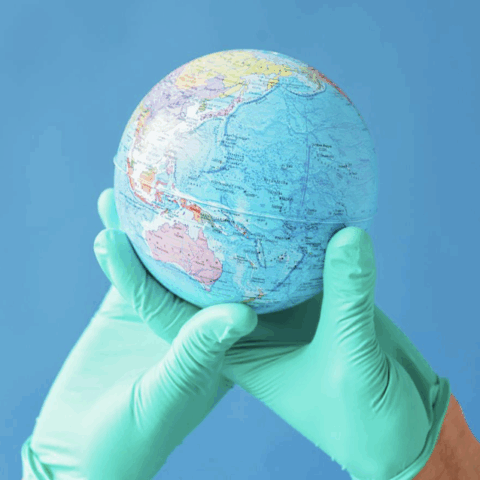 Gloved hands holding up a globe