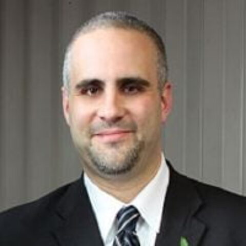 Tom O'Toole in front of gray background