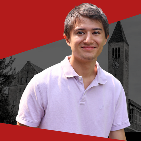 Student in pink polo shirt with Cornell Clock tower behind him