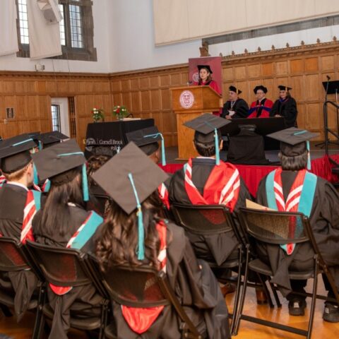 Group of EMHA and MHA graduates listening to Dean Barry's commencement speach